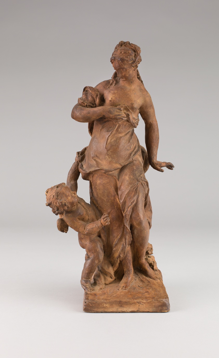 Terracotta sculpture of a standing woman. Her right arm clutches fabric as a Cupid on her right pulls the fabric at her waist.