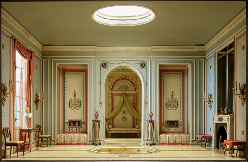Miniature model of a large, stately room with a circular marble tub sunk into the floor's center and fireplace at right. A central archway reveals a sitting area beyond.