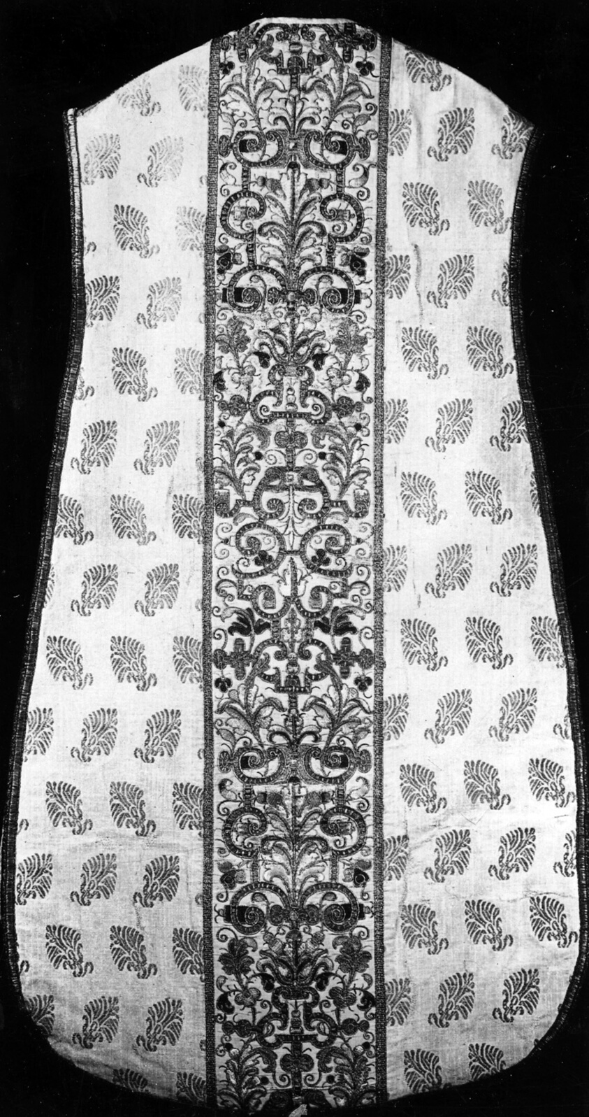 Sleeveless vest, photographed in black and white, featuring a leaf motif and a decorated panel down the front.