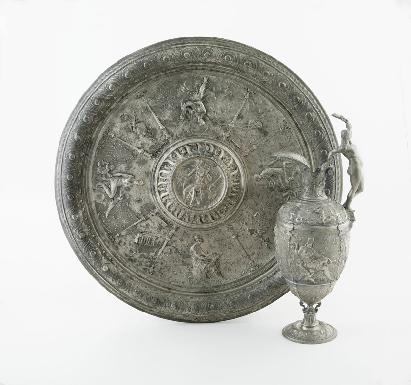 Pewter jug and basin, lavishly decorated with floral motives and anthropomorphic figures.