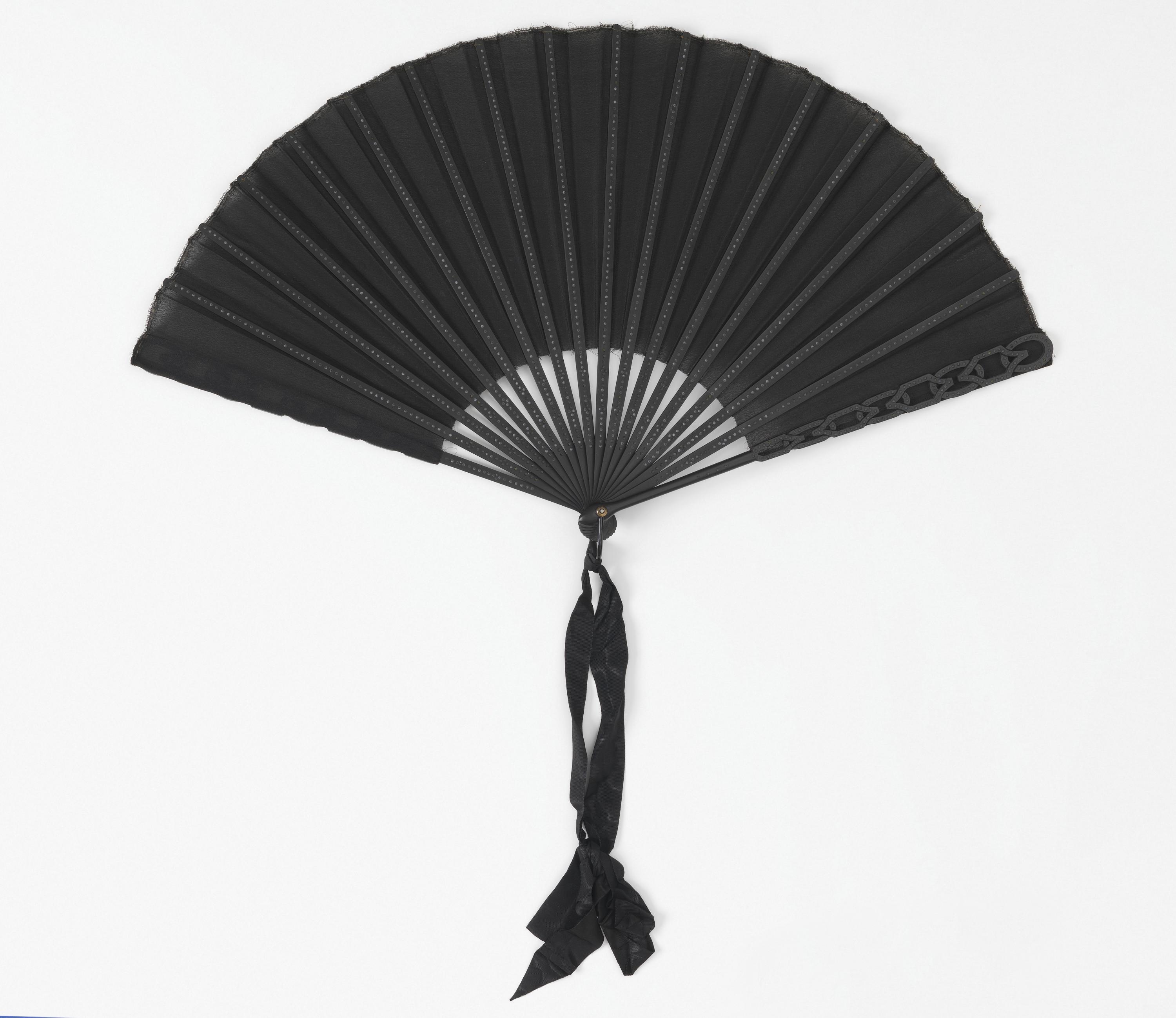 Pleated mourning fan — Pleated mourning fan by Duvelleroy, Paris, France, founded 1827. Silk crepe leaf, painted wood guards and sticks inlaid with black spangles, guards cut à jour, horn washer and metal loop at the rivet, silk ribbon.