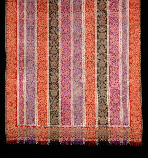 A richly patterned shawl with alternating stripes of curling floral motifs, attributed as probably French.