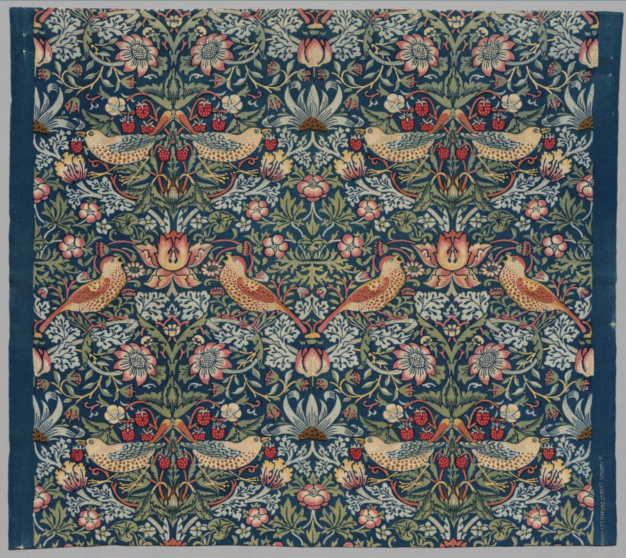 Pairs of birds, strawberries, flowers and curling leaves repeat across a dark blue textile.